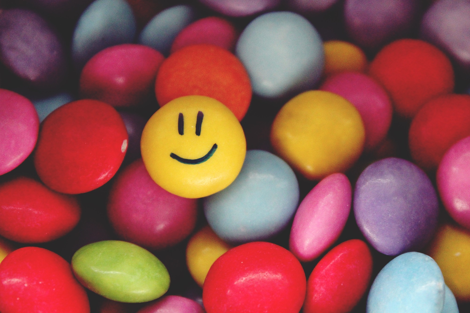 Smiley Candy on a Pile of Colorful Ones